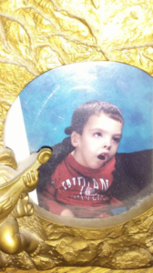 A keepsake portrait of Jason in a decorative gold frame