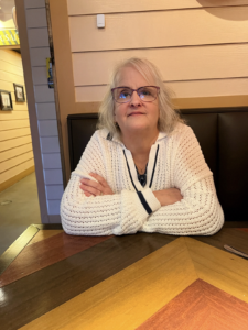 Julie Bailey Miller seated at a table